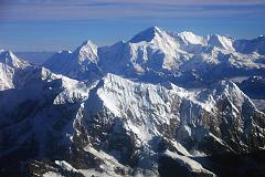13 Kathmandu Mountain Flight 07-4 Cho Oyu Above Numbur and Khatang With Nangpa La and Nangpai Gosum I Cho Oyu (8201m) dominates the view from the Kathmandu Mountain Flight as the plane leaves the Rolwaling area. The closest mountain is Numbur (6959m) on the left connected by a ridge to Khatang (6853m) on the right. The Nangpa La pass between Tibet and Nepal is in the upper left, and the pointed peak to the left of Cho Oyu is Nangpai Gosum I (7351m, also called Cho Aui or Pasang Lhamu Chuli).